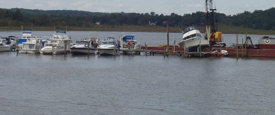 Crane lift at a barge dock during marine repair work