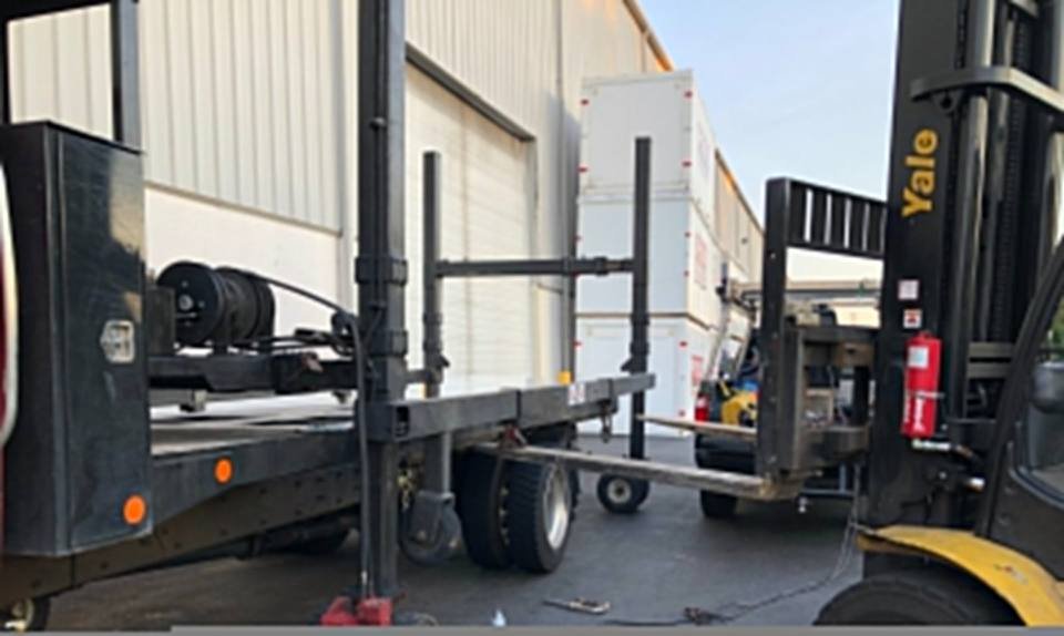 Mobile welding repair at a warehouse loading area