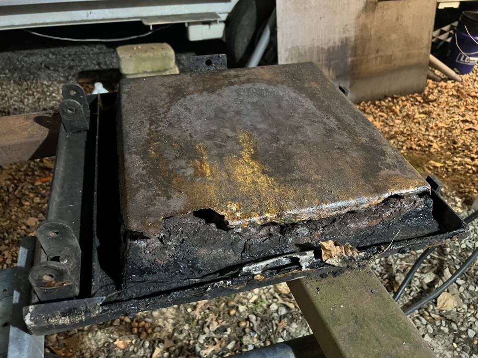 Outdoor wood boiler firebox door rusted and burned through before repair